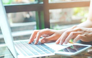 Woman at a laptop for wellness business blogging